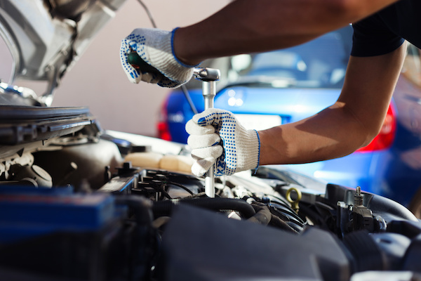 Mechanic working on car engine