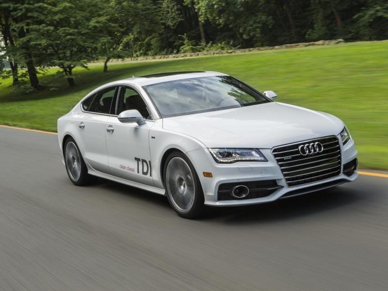 A sporty coupe with its trunk open, revealing a spacious cargo area filled with luggage and sports equipment