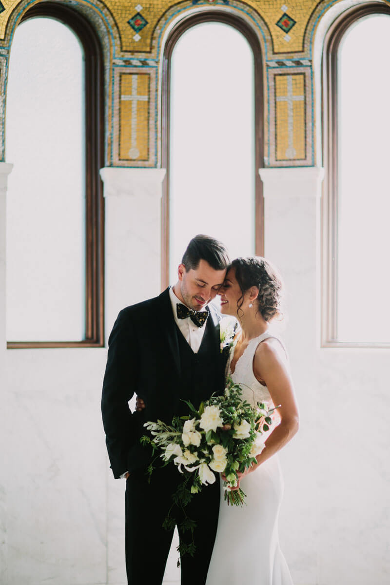 bride and groom in front of dome