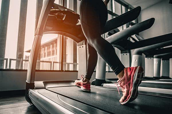 Woman running on treadmill gym equipment