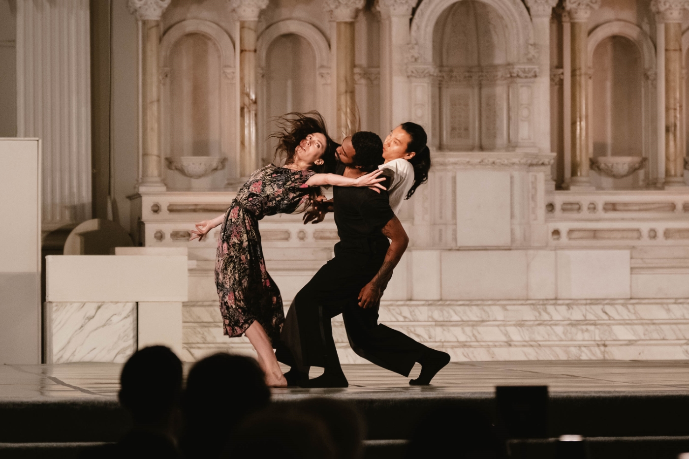 a group of male dancers pull a female dancers back. her back is arched and her hair is flying. at a performance at a dance gala at Vibiana in Downtown Los Angeles