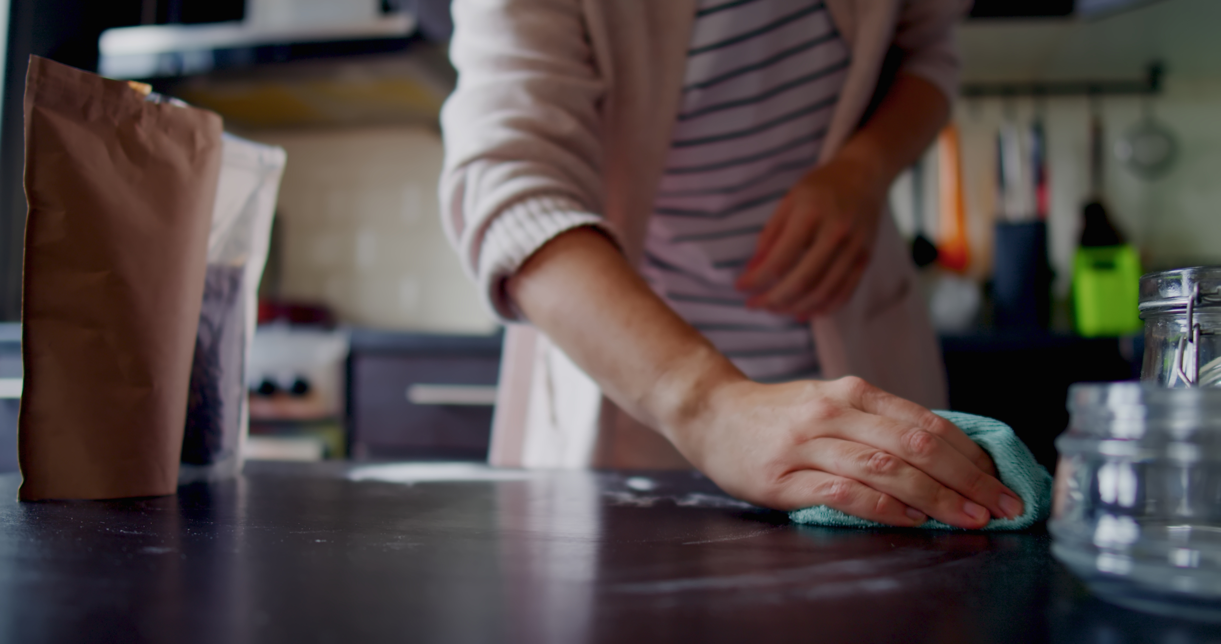 Woman is organizing food in her kitchen pantry