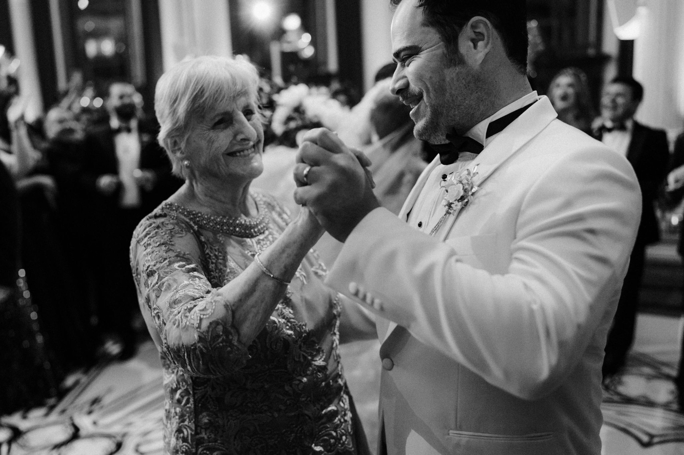 a groom dancing with an older wedding guest at DTLA wedding reception indoors