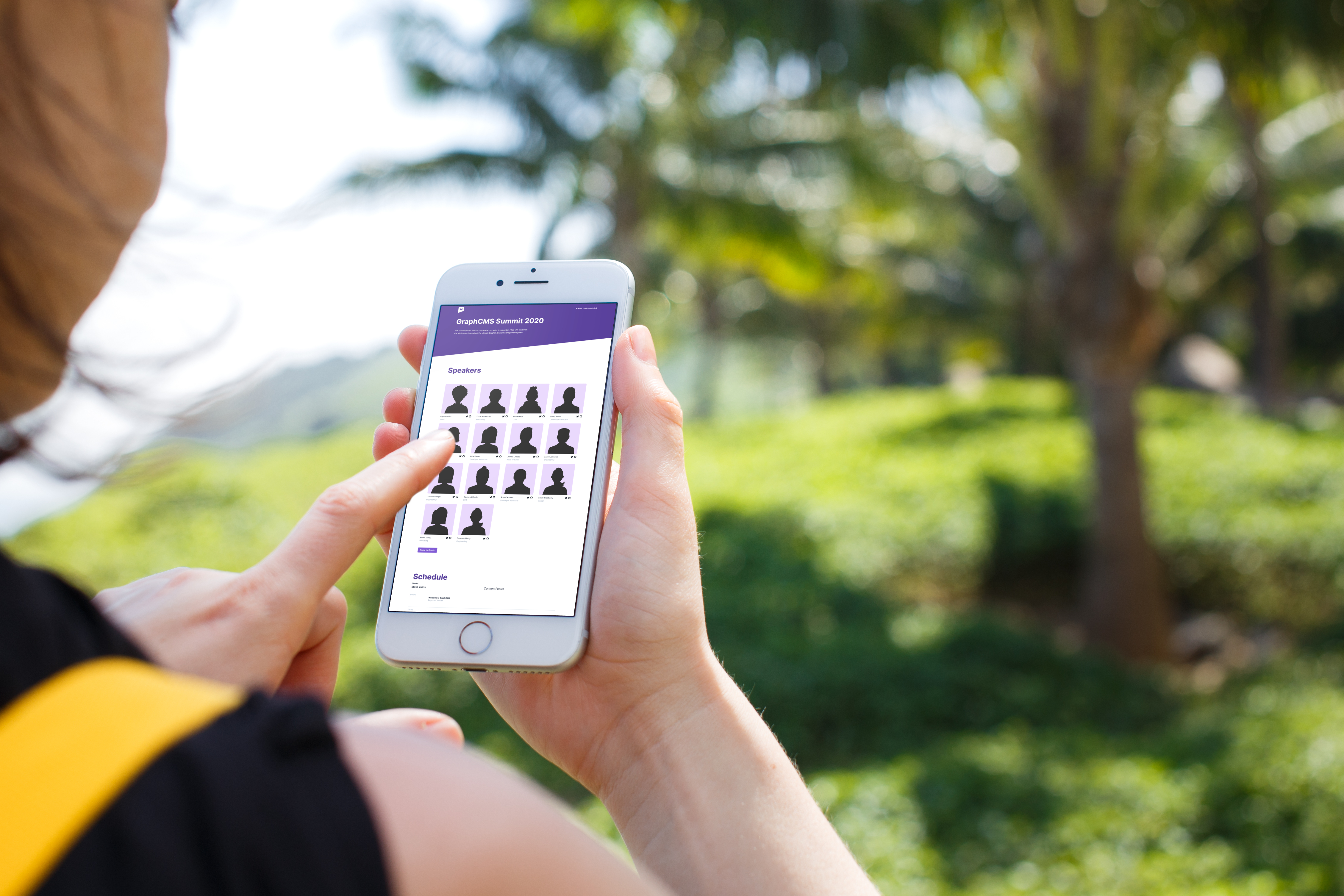 woman holding iPhone 7 in front of the palm tree