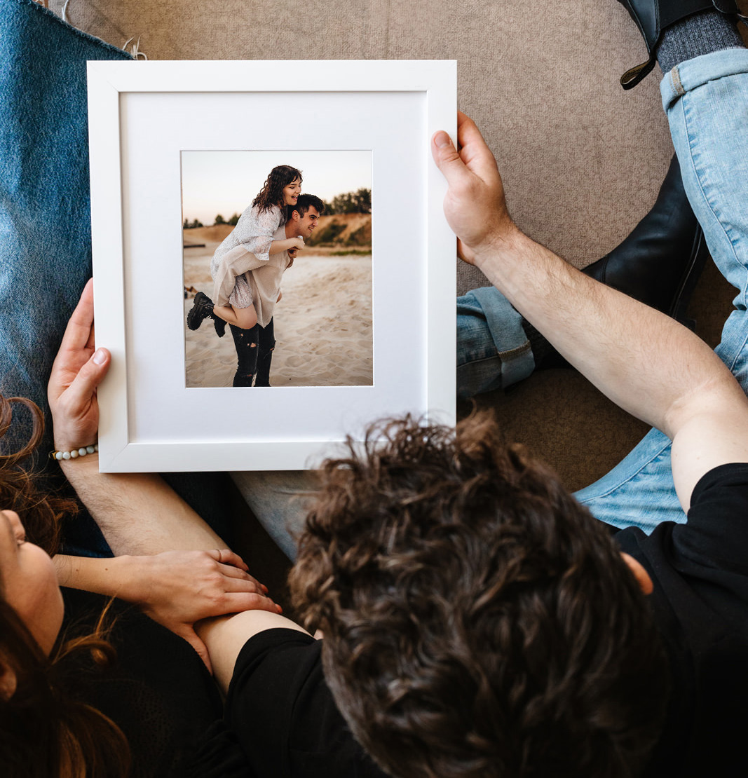 Framed print of couple at the beach.