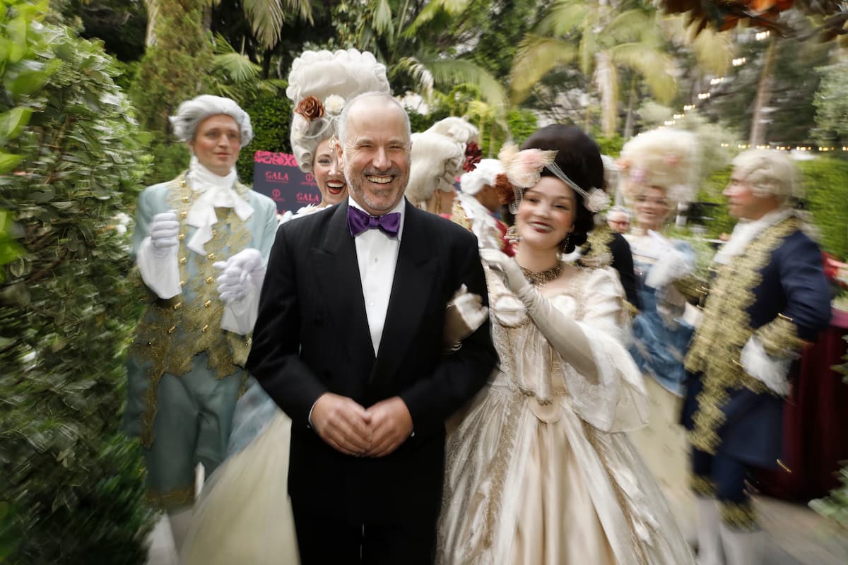 man in tux with performers