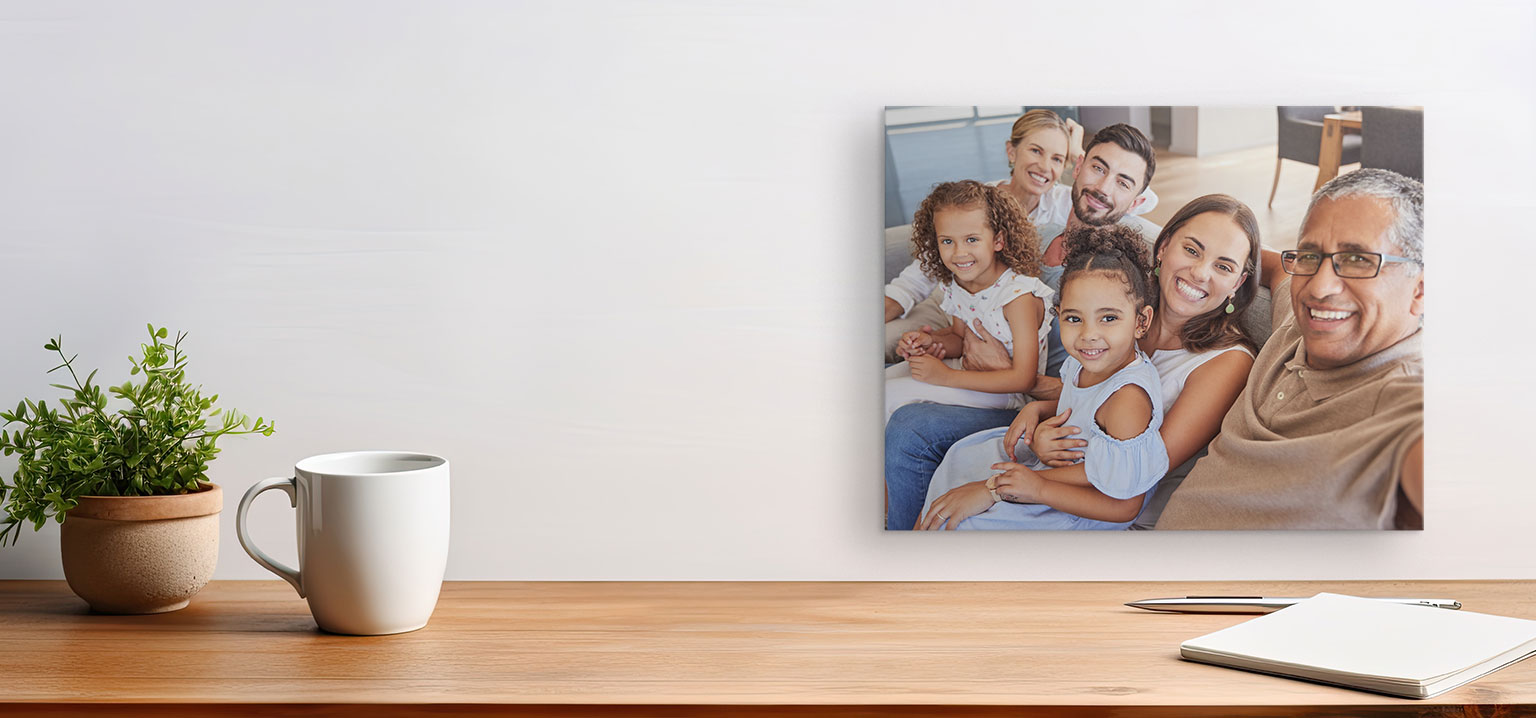 A canvas featuring a photo of a family posing on the couch together for a selfie