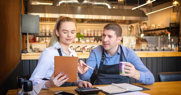 Restaurant workers discussing restaurant equipment leasing