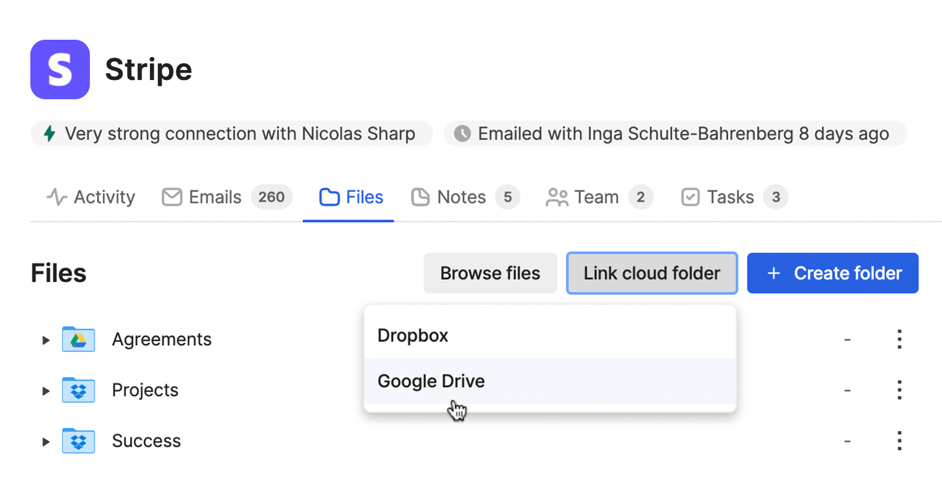 A cursor hovers over the dropdown option to link a Google Drive folder to a record. Another option is shown to link a Dropbox folder. Beneath the dropdown is a folder structure with both Google Drive and Dropbox logos on the various folder icons. 