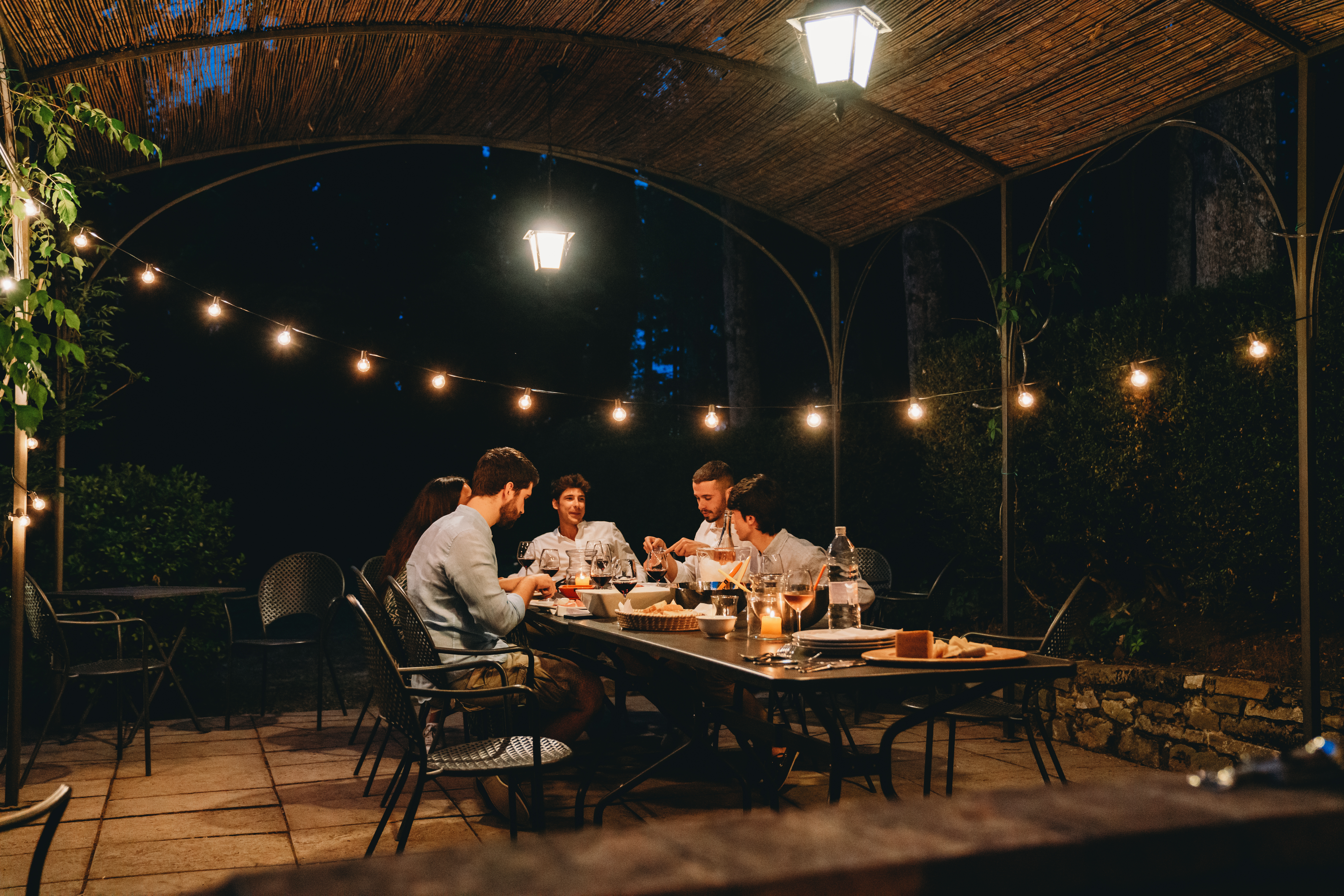 Friends are dining together in a farmhouse at night