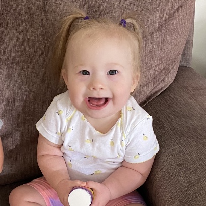 A young girl with Down syndrome smiling