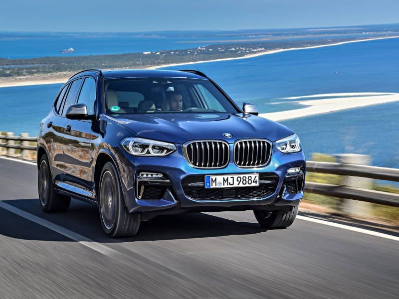 2018 BMW X3 front three quarter driving along ocean ・  Photo by BMW 