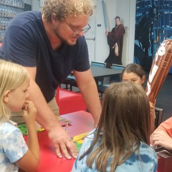 Kids learning how to play a board game