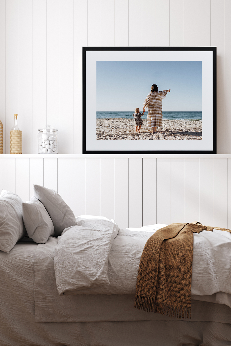 Framed print of mother and child on the beach in bedroom