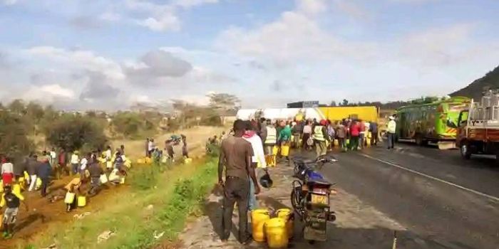 Kenyans scramble for oil after a Trailer Carrying Crude Oil Overturns Along Mombasa - Nairobi Highway