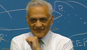 Lecturer Amar Bose in front of chalkboard.