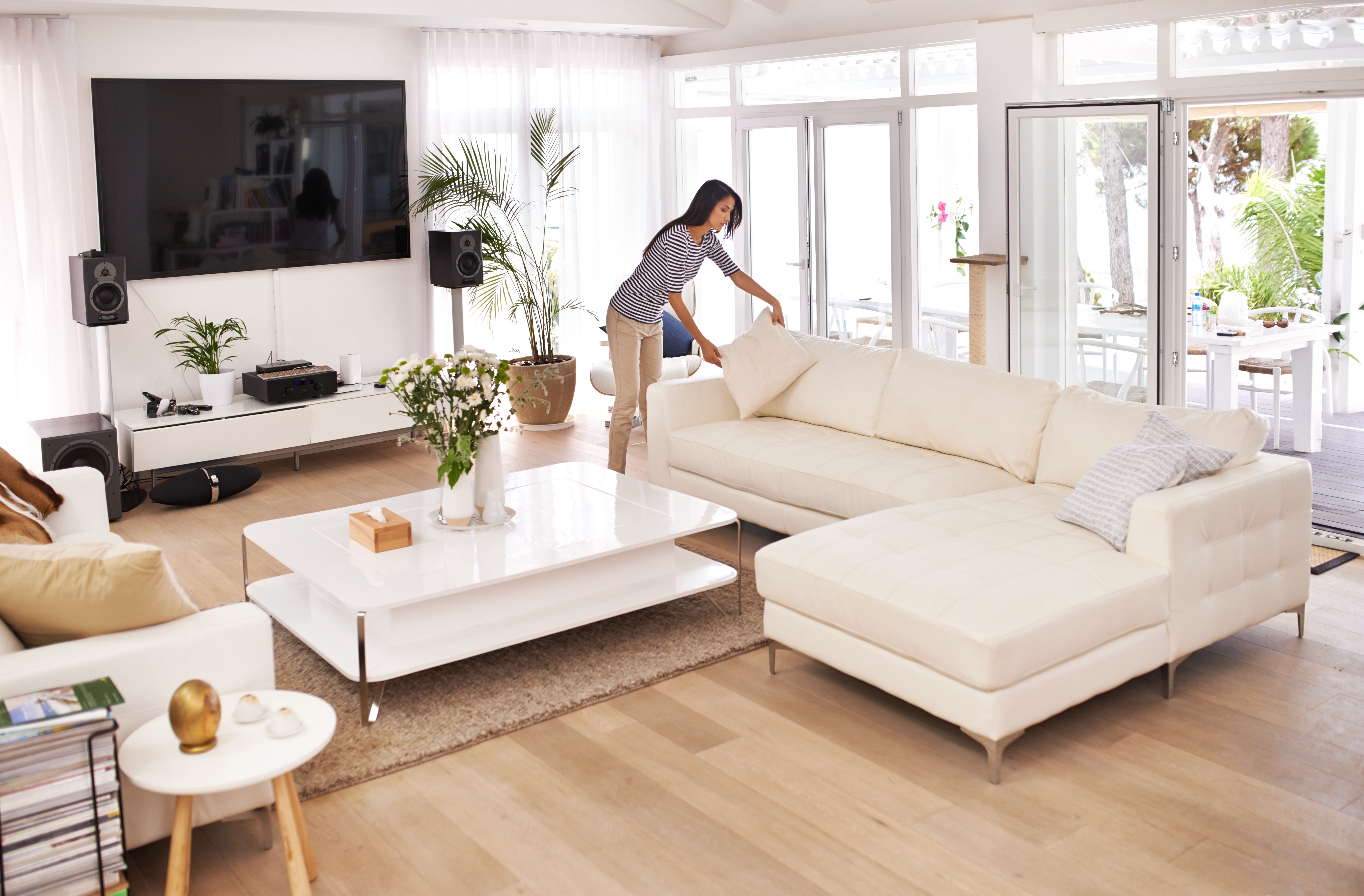 woman rearranging furniture and tidying the home