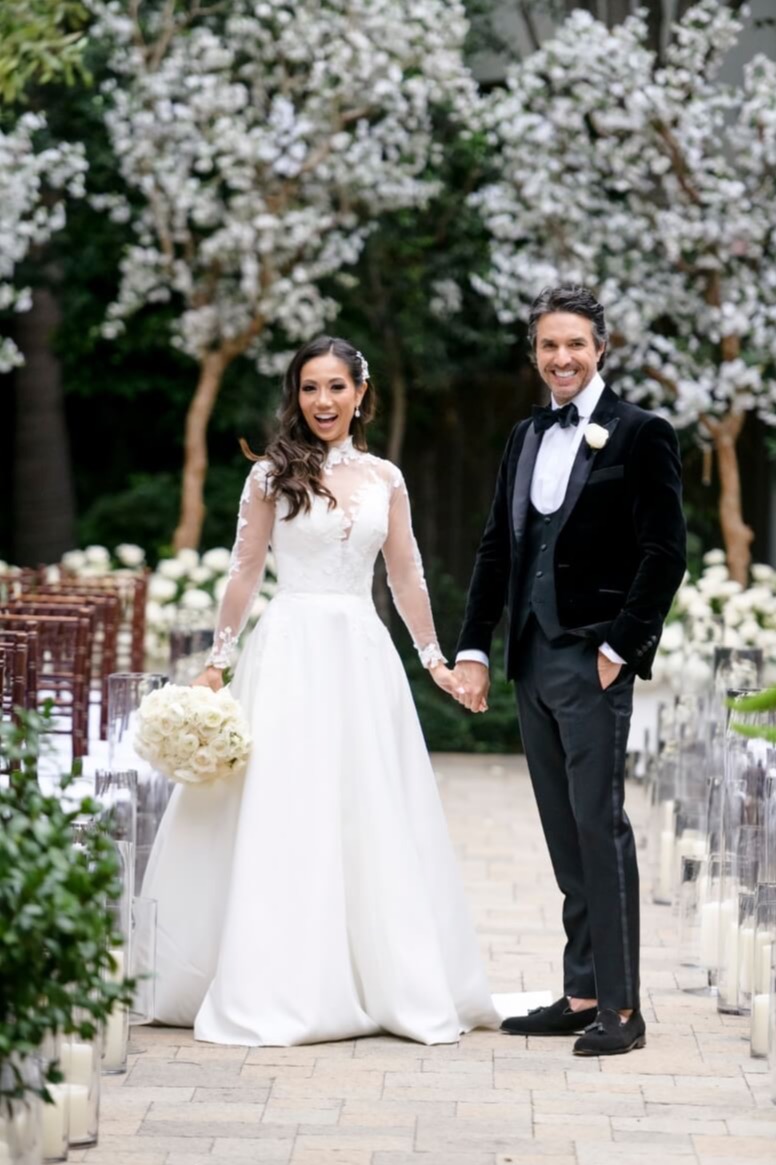 bride and groom with white trees in back 