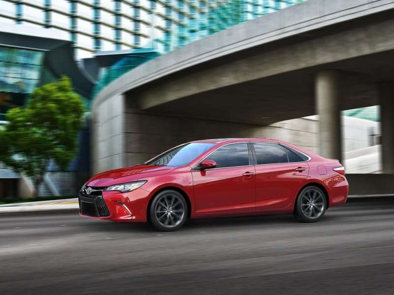 red 2015 toyota camry driving 