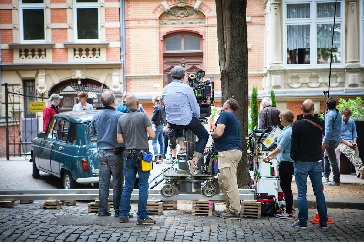 Production crew filming on cobblestone street.jpg