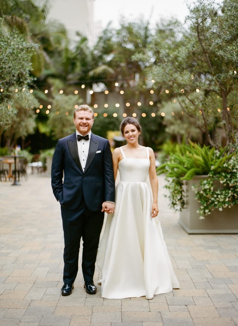 bride and groom holding hands