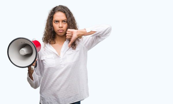 angry young hispanic woman with megaphone making thumbs down gesture for remove google review