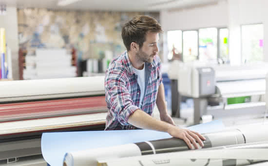 Technician working on a large-scale printer