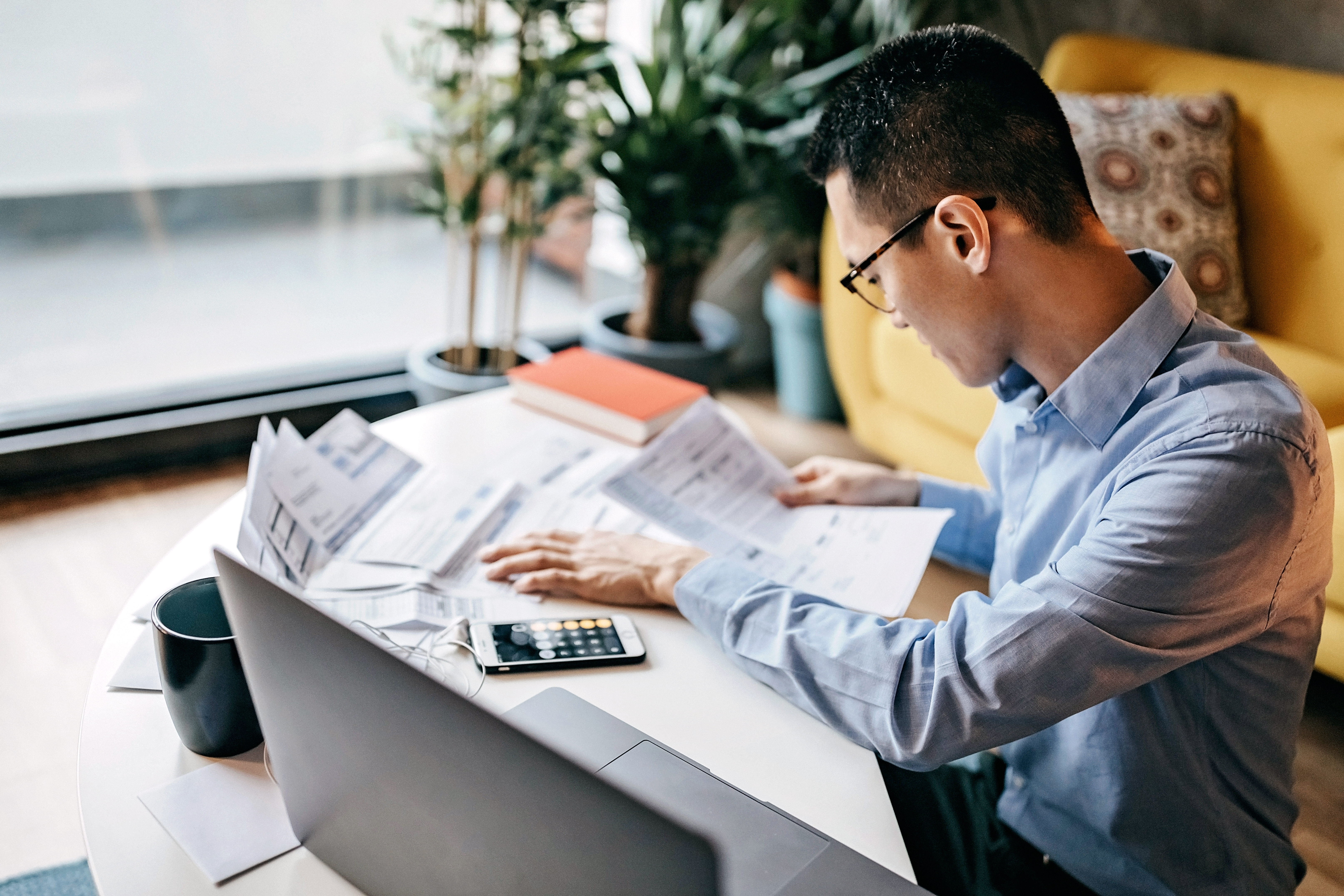 Man looking at finances and paperwork, working from home