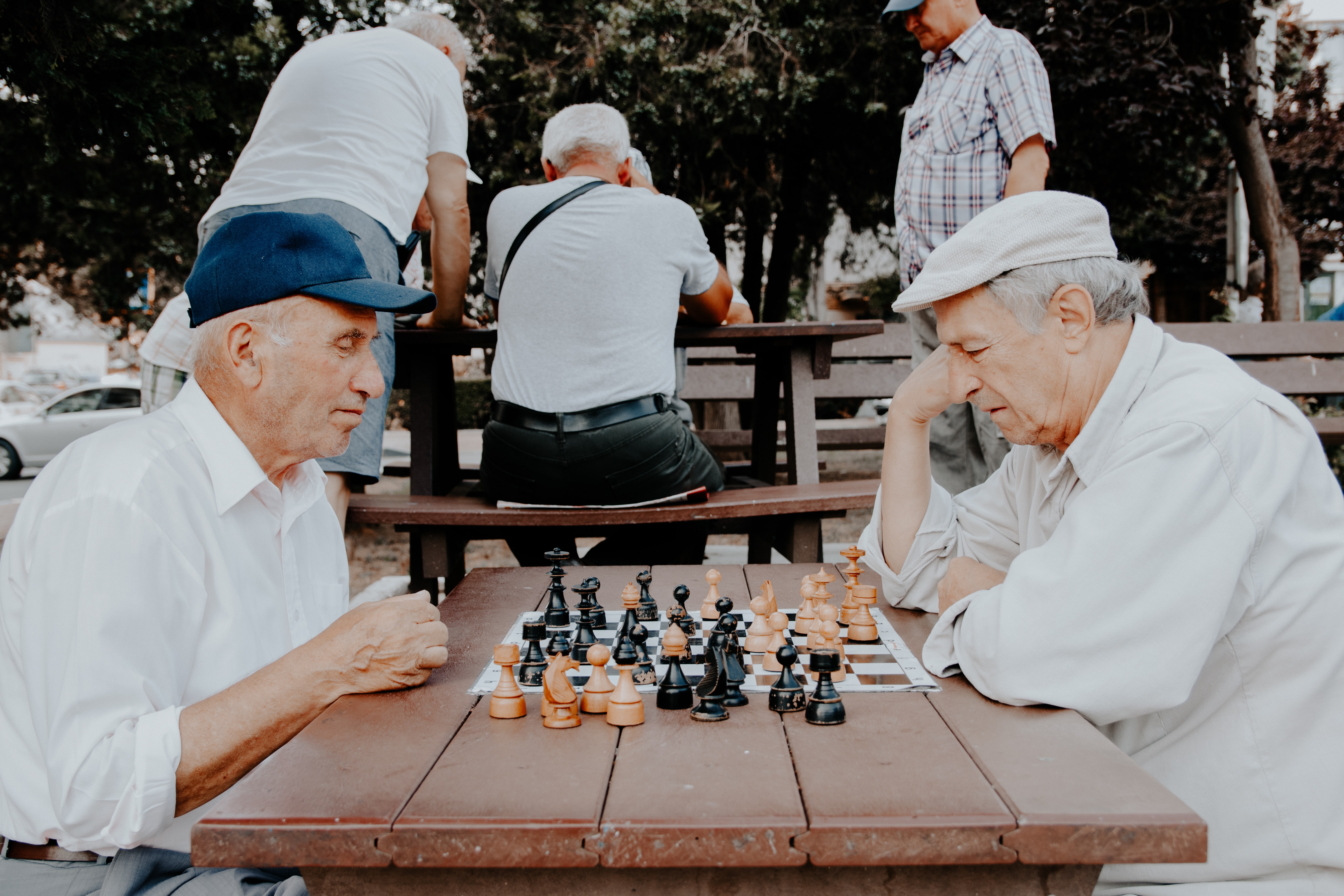 Zwei ältere Männer sitzen nachdenklich an einem Schachspiel