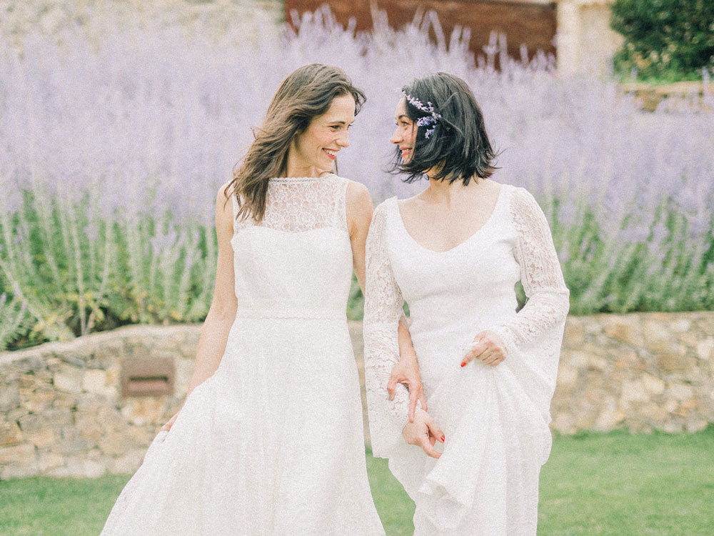 two brides smiling in lavender garden