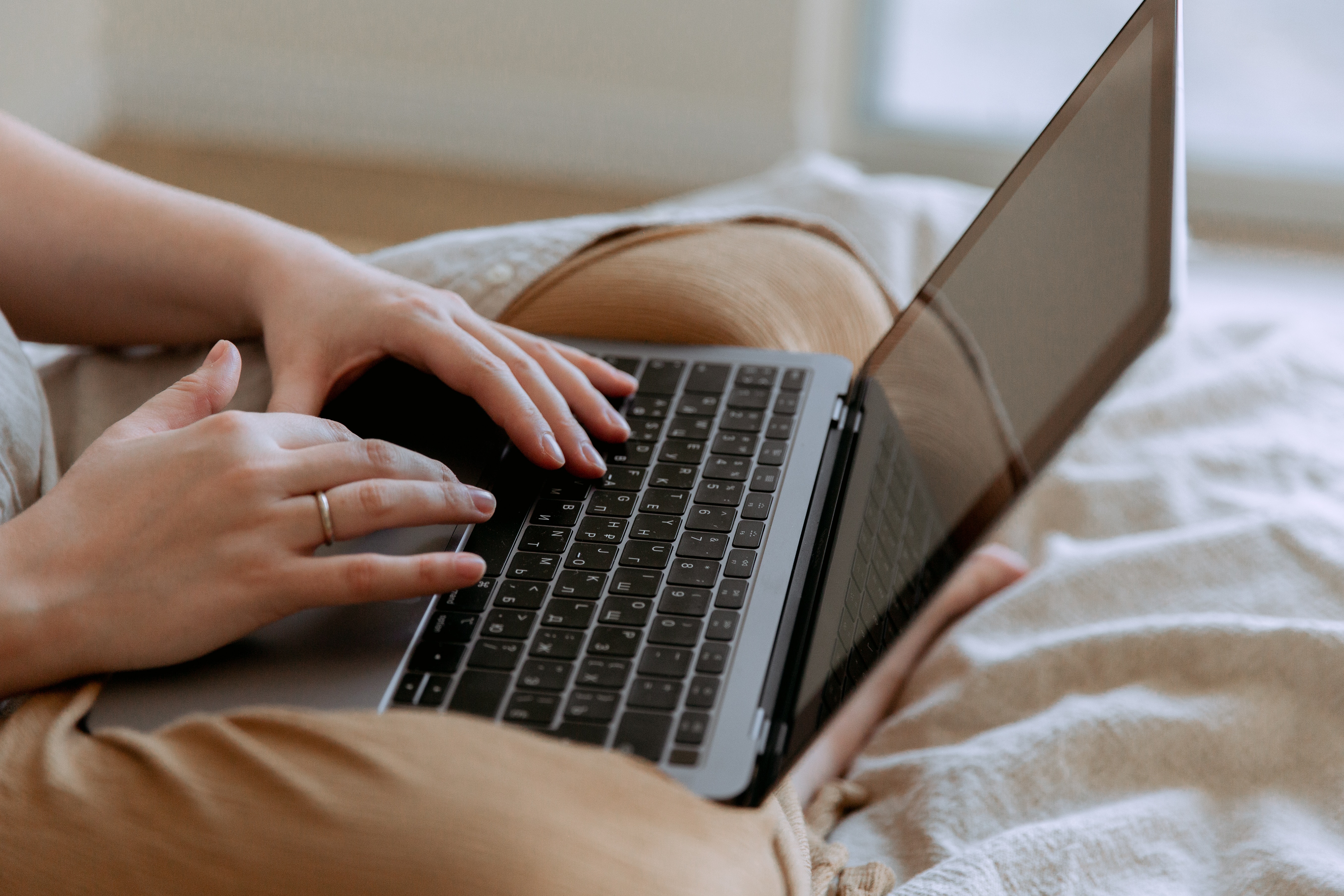  A person holding a laptop in their lap