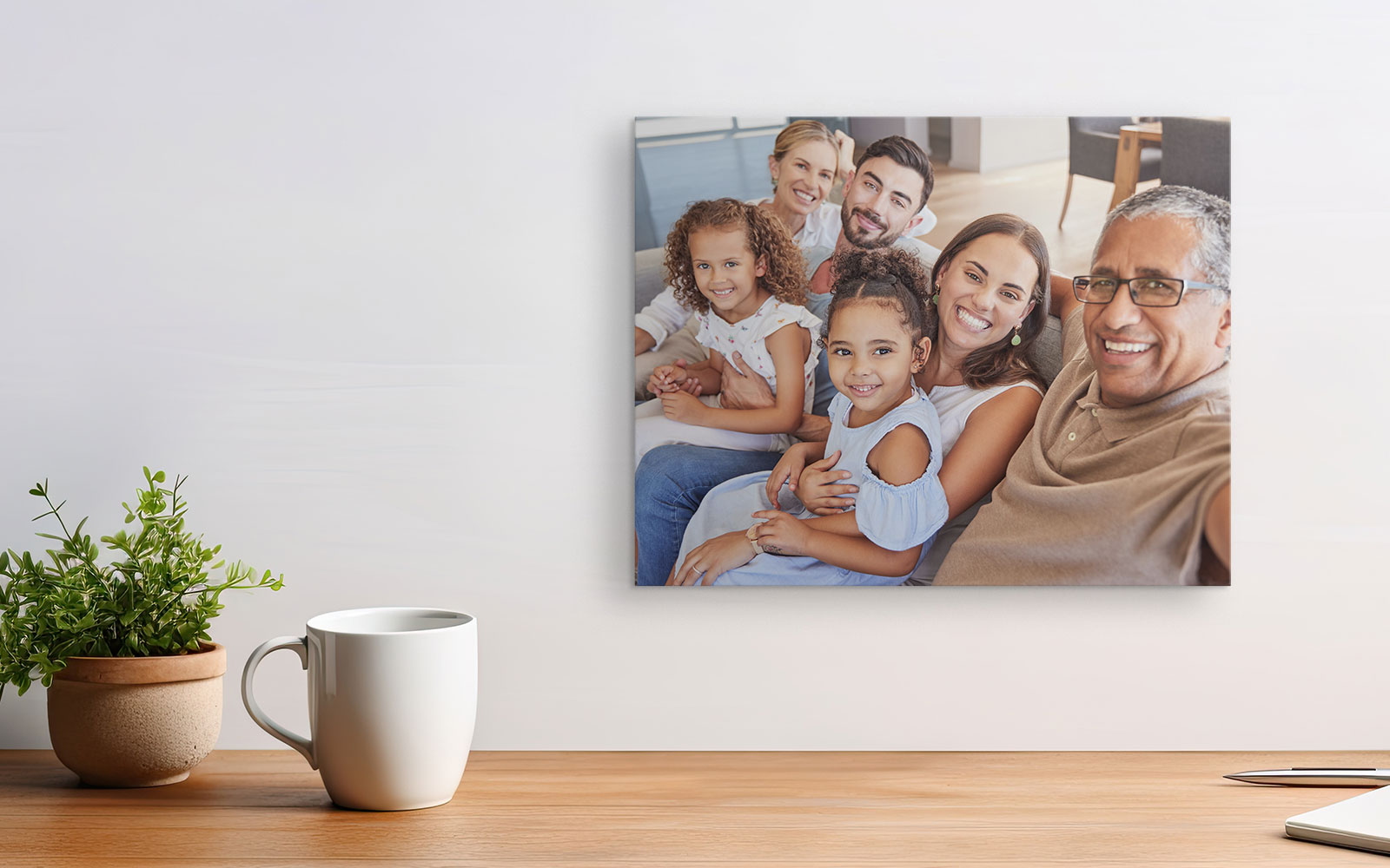 A canvas featuring a photo of a family posing on the couch together for a selfie
