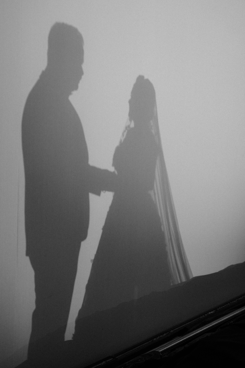 silhouette of a bride and groom holding hands