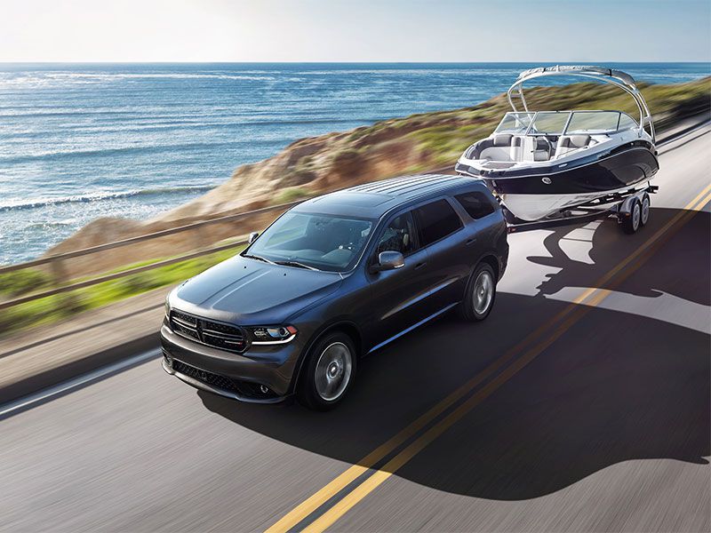2016 Dodge Durango towing a boat on the road ・  Photo by Fiat Chrysler Automobiles 