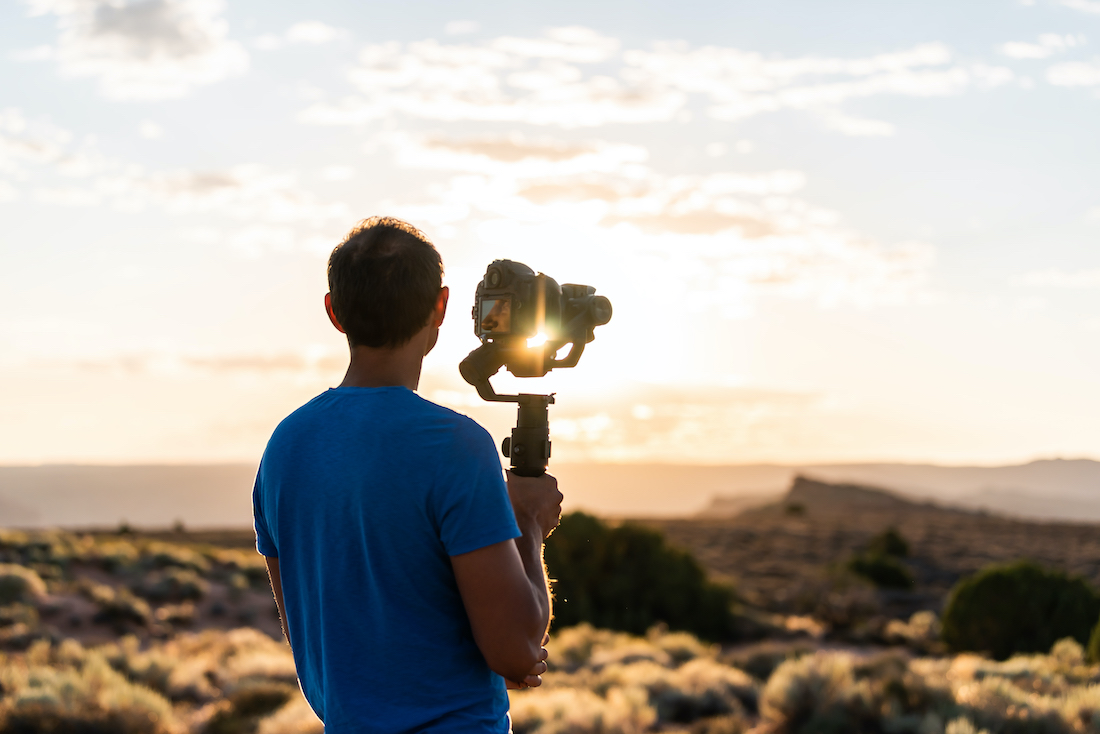 Filmmaker with camera outdoors-1182971122-1100p.jpg