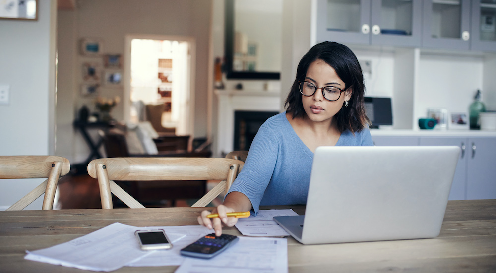 woman calculating a budget with laptop.jpg