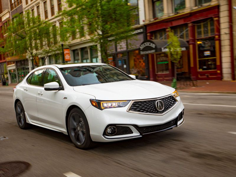 2020 Acura TLX white driving in city ・  Photo by Acura 