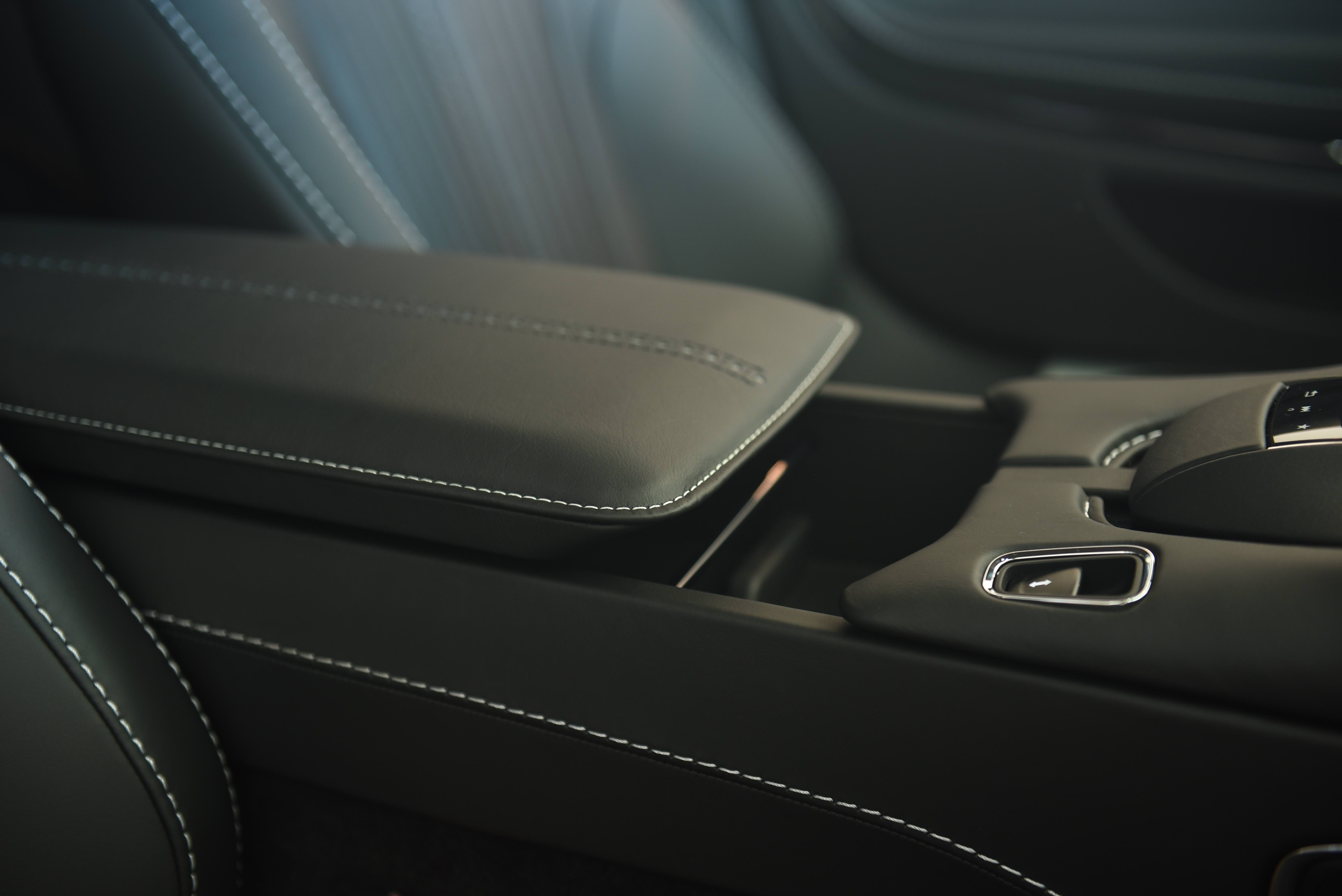 close up of an Aston Martin centre console armrest that uses an Accuride slide to adjust.