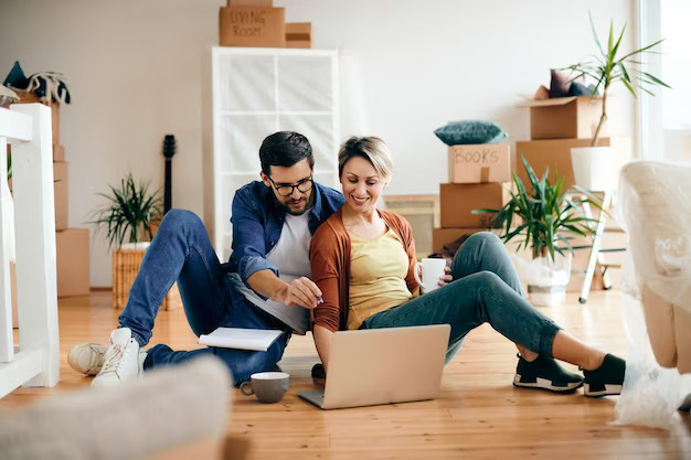 happy-couple-using-laptop-while-relaxing-floor-their-new-home_637285-12338.jpg