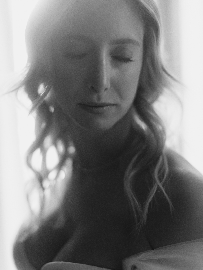 a bride stands in front of a window before her wedding ceremony in downtown Los Angeles