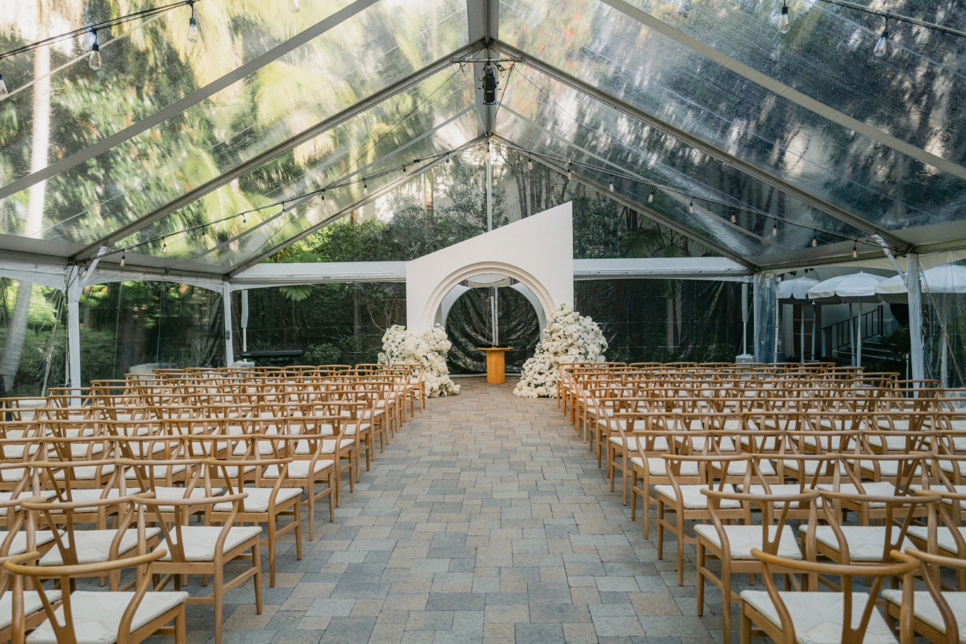 an architectural chuppah under a tent with chairs lined up for a ceremony in DTLA cathedral wedding