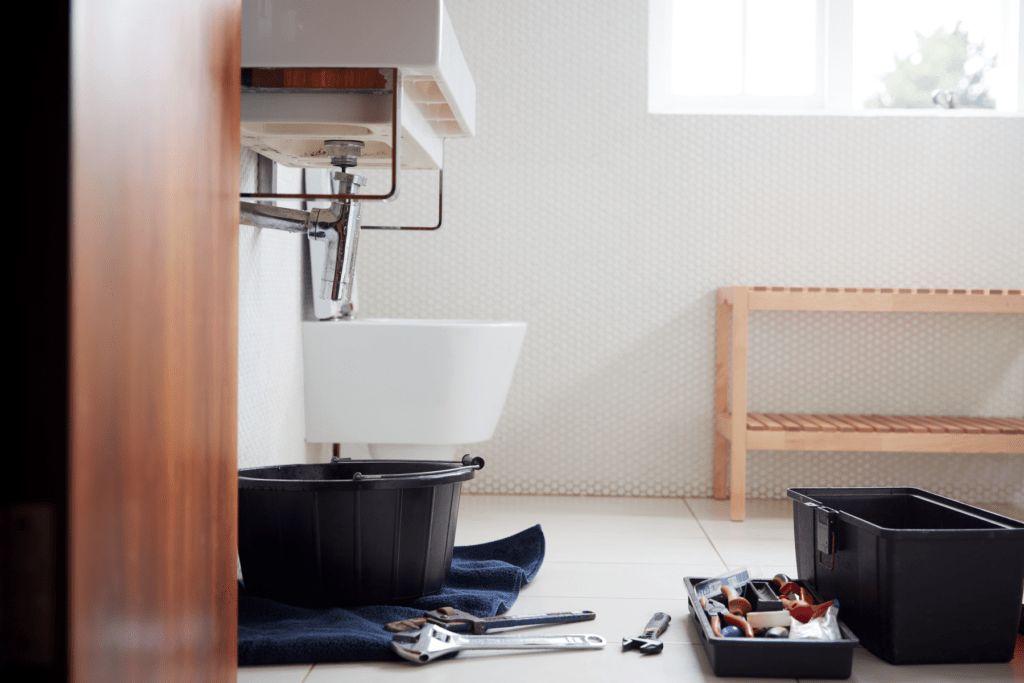 Bathroom sink plumbing being installed