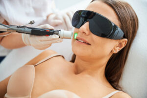 Woman receiving laser hair removal from esthetician