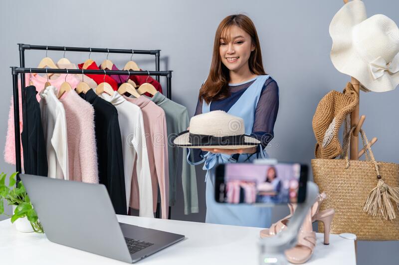 woman-selling-hat-clothes-online-smartphone-live-streaming-business-e-commerce-home-young-213289066.jpeg