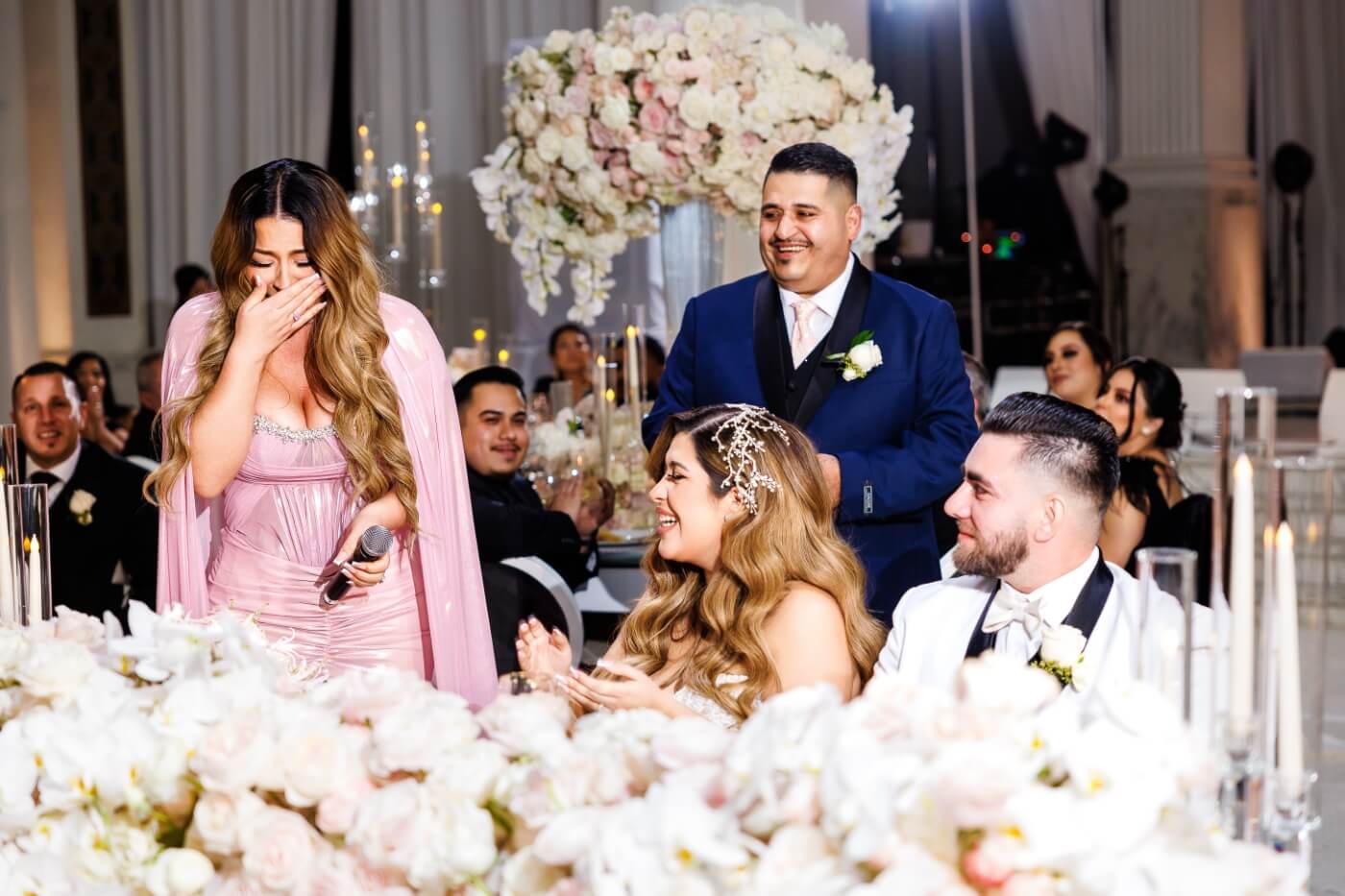 woman giving speech to bride and groom