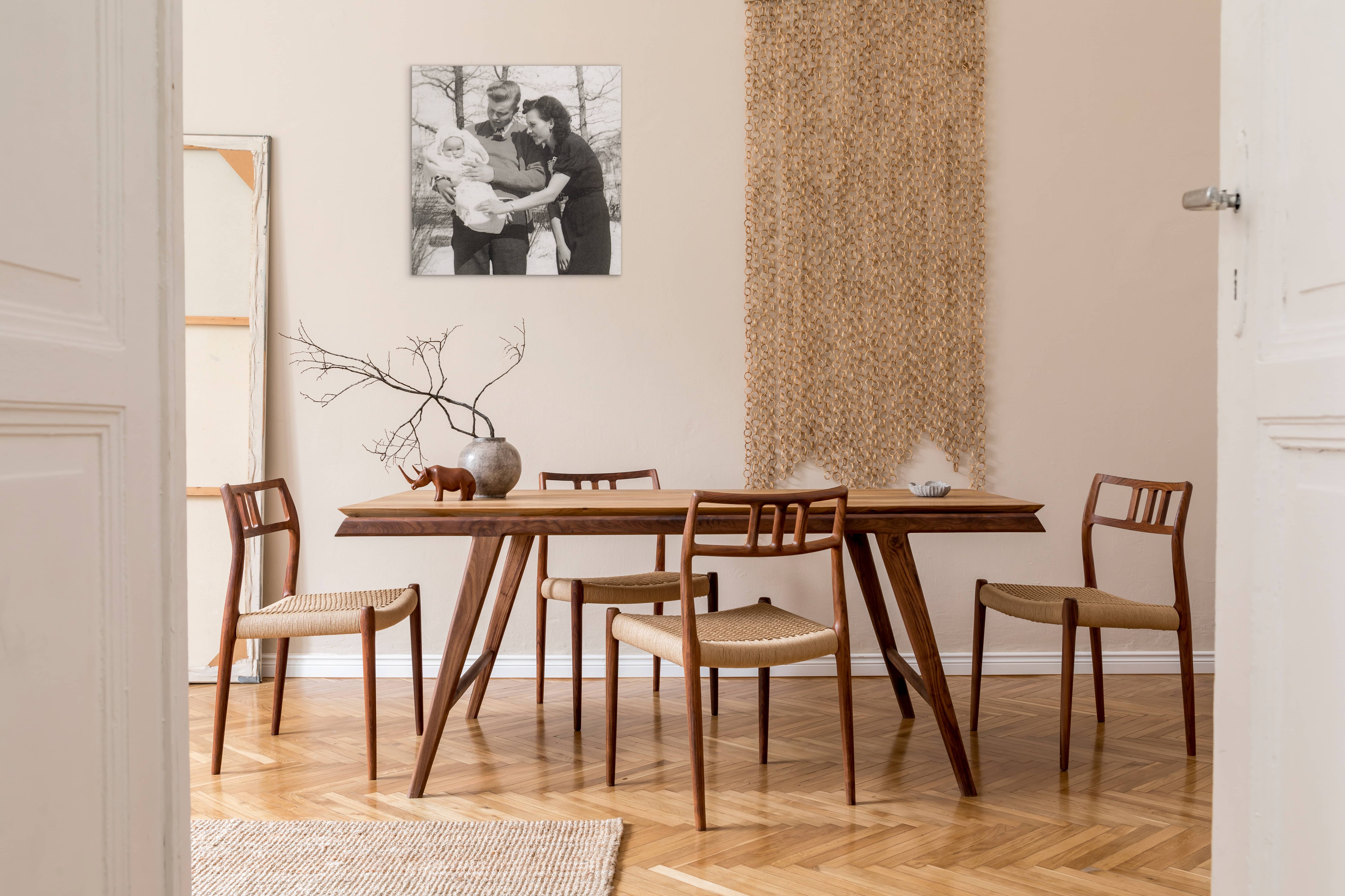 Canvas print in dining room of mother and father with their baby