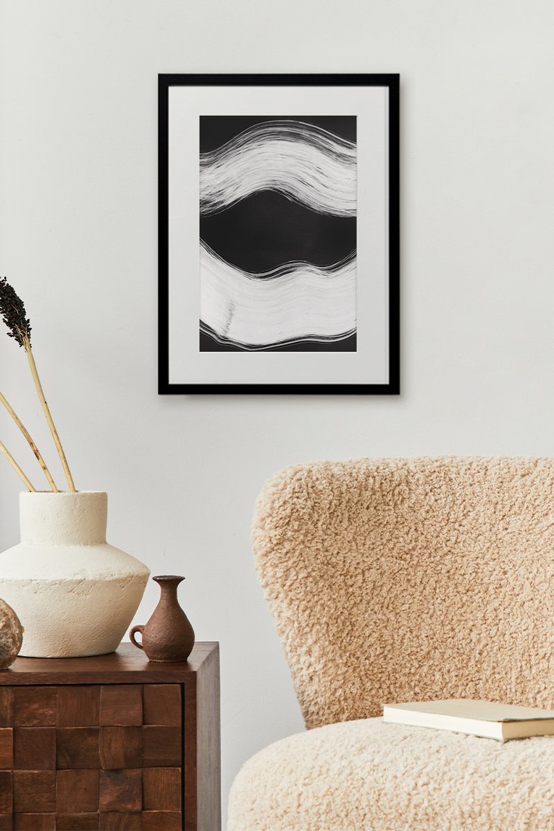 Framed print of black and white abstract art in living room