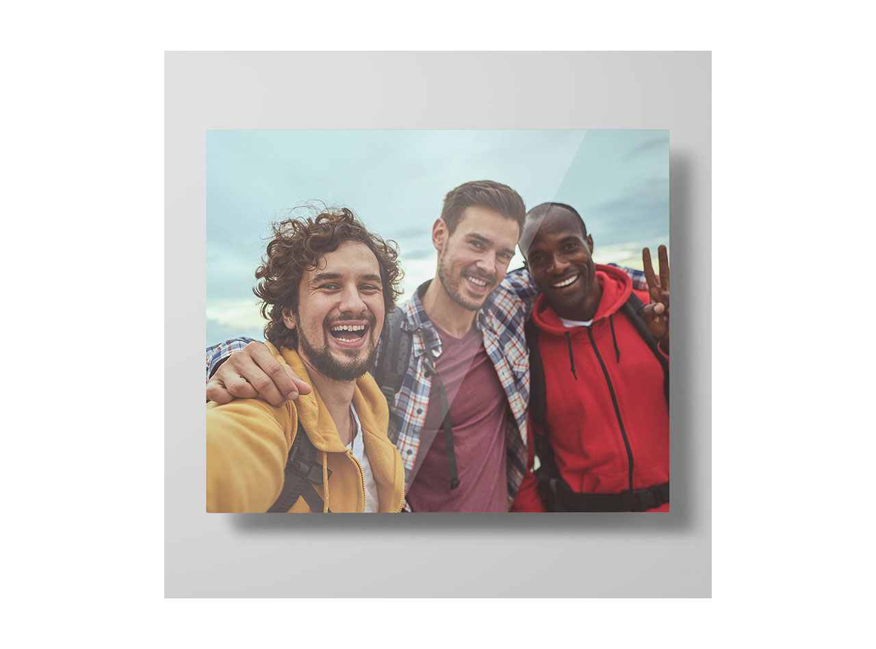 A metal print depicting an image of three happy friends on vacation
