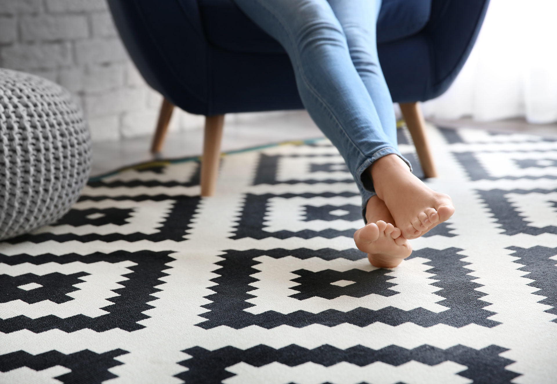 Woman reclining with her feet on a rug