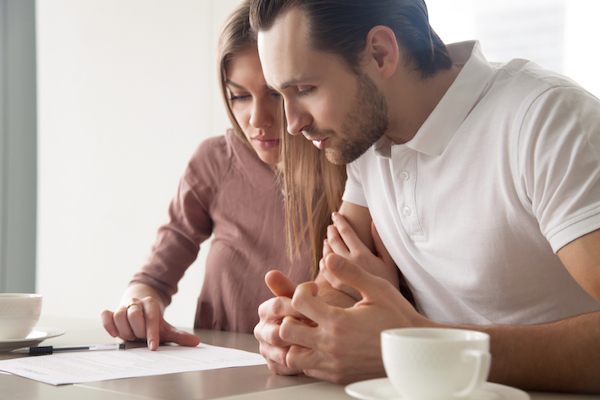 couple carefully studying commercial rent agreement